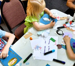 Looking down at children drawing on a table