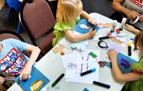 Looking down at children drawing on a table