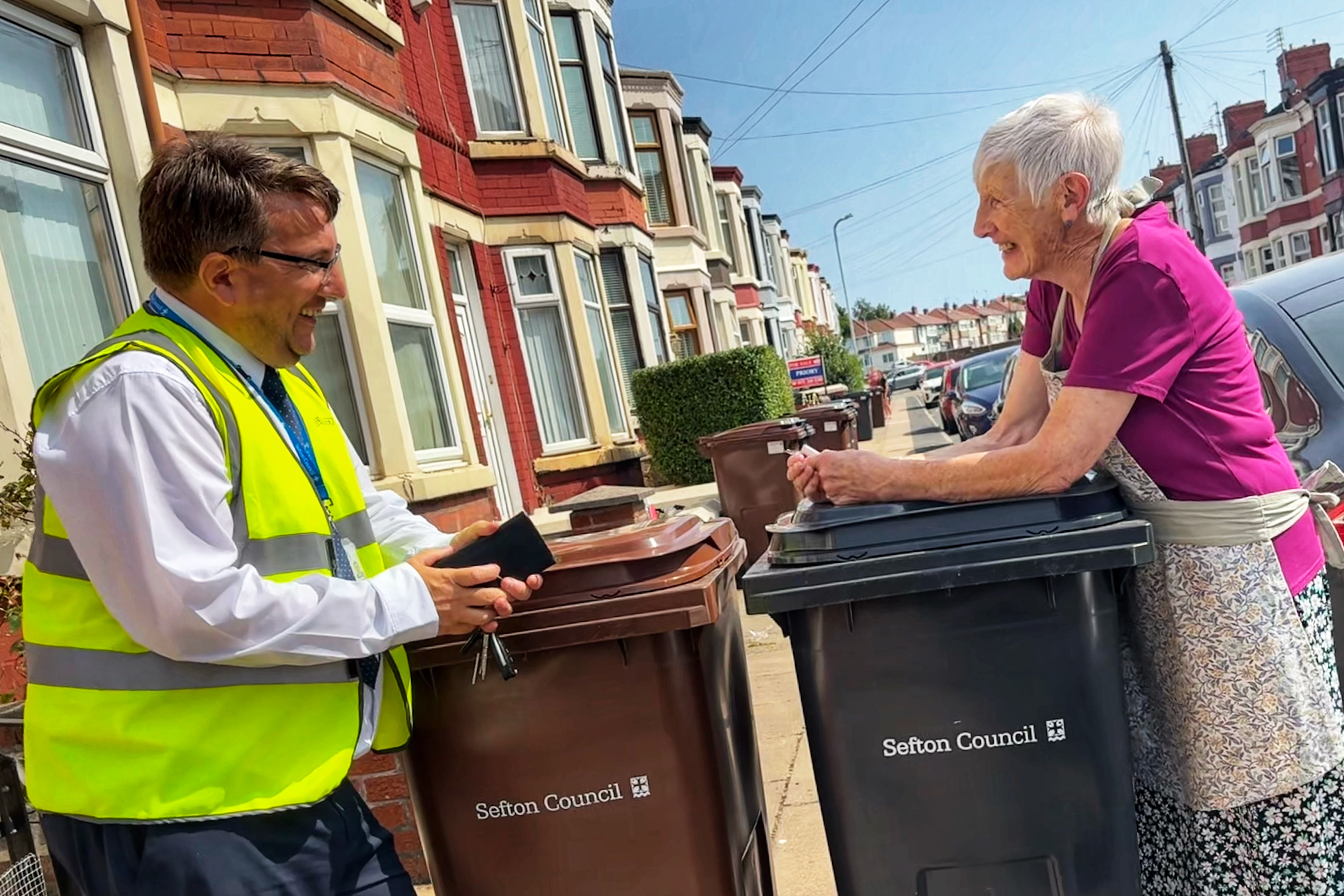 Kevin Shields, from Sefton Council’s Waste Management & Street Cleansing team, delivers new wheelie bins to a resident in Derby ward in Bootle.